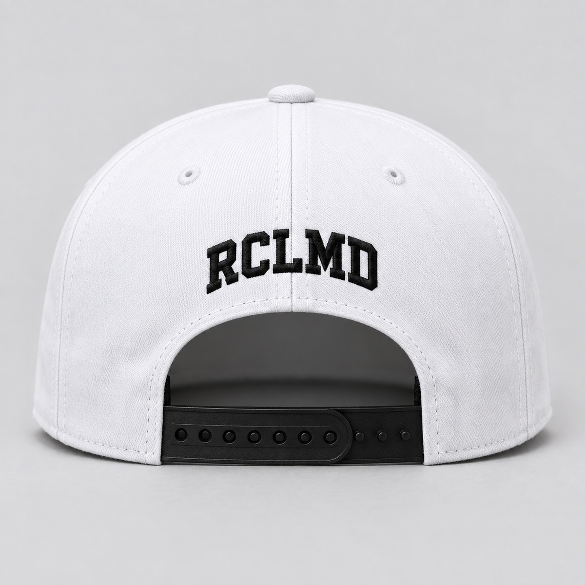 RCLMD snapback in white, back view with black RCLMD embroidery